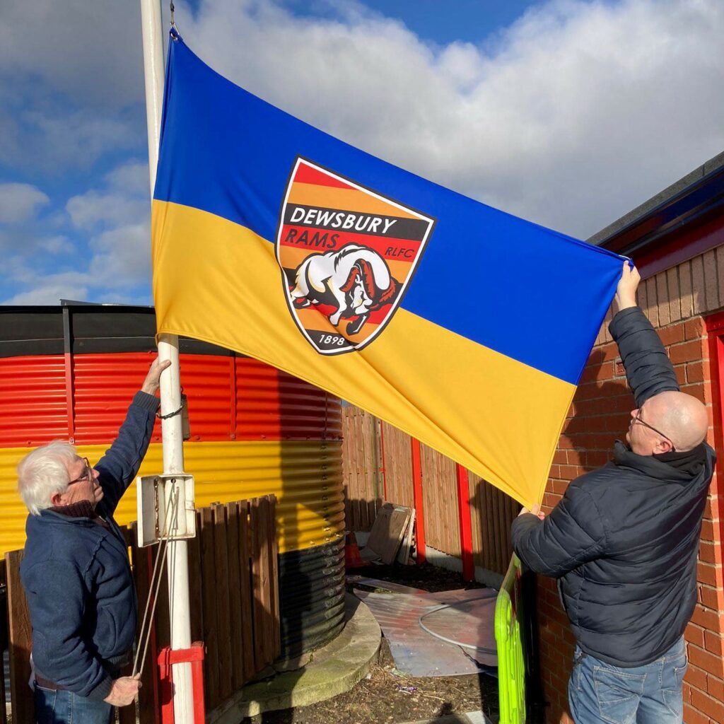 Tony Healy and Neil Coulson raising the flag on Saturday morning.